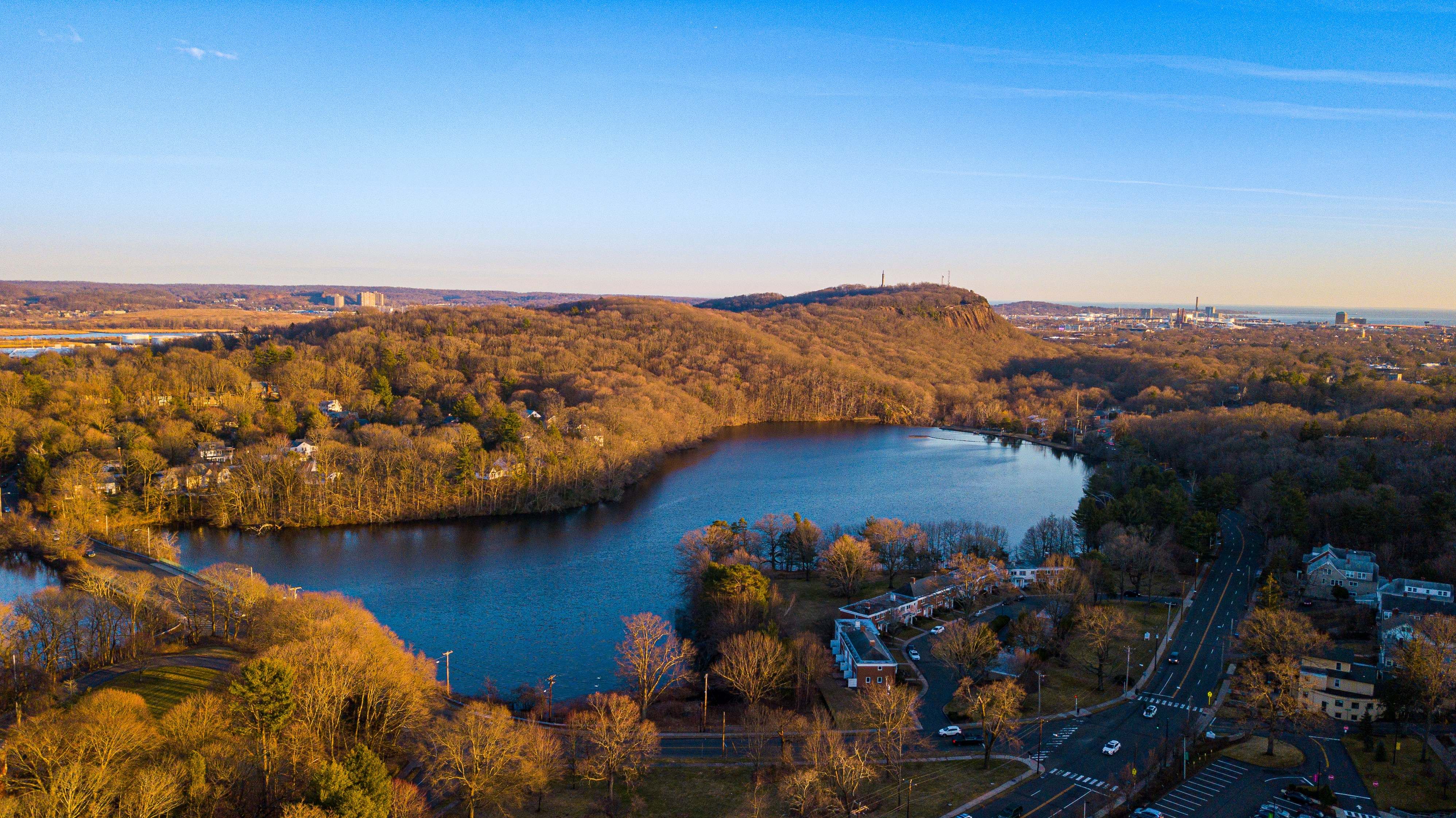 Aerial view of the hills and lake outside town, golden hour